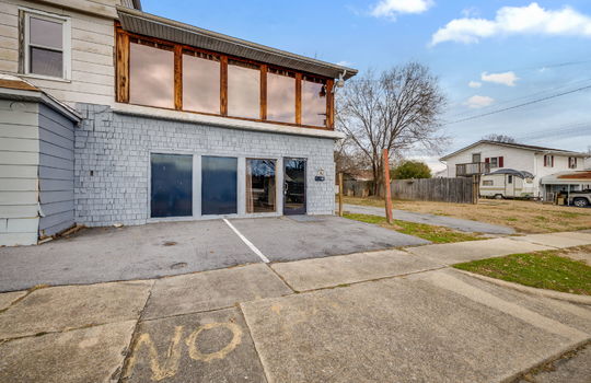 ground level apartment for lease, wood siding, windows, glass door