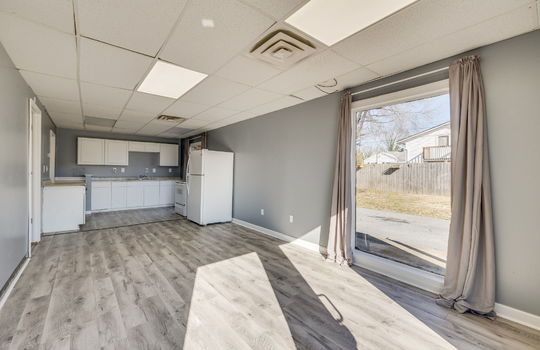 living room, window, luxury vinyl flooring, electric range, refrigerator, cabinets, sink, open floor plan