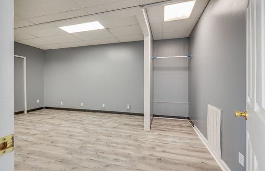 bedroom, luxury vinyl flooring, ceiling tiles, fluorescent lighting