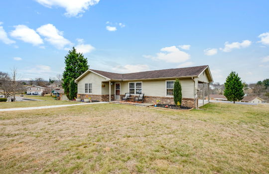 ranch style home, front yard, gravel sidewalk, landscaping, front door, vinyl siding