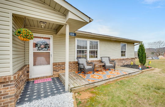 front door, covered front door, landscaping, vinyl siding, storm door,