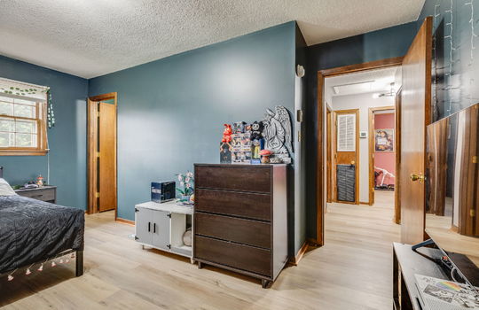bedroom, luxury vinyl flooring, door to hallway, windows, door to ensuite bath