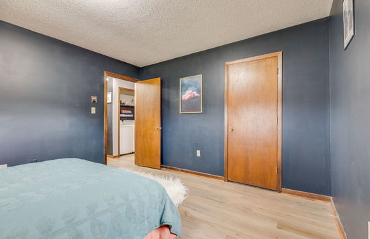 bedroom, luxury vinyl flooring, closet door, door to hallway
