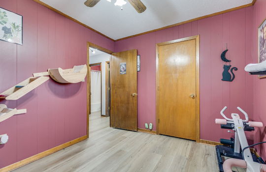 third bedroom, luxury vinyl flooring, painted paneling walls, closet, ceiling fan
