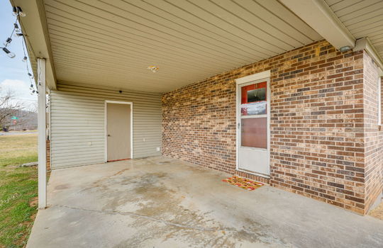 carport, back exterior door, vinyl siding, brick exterior