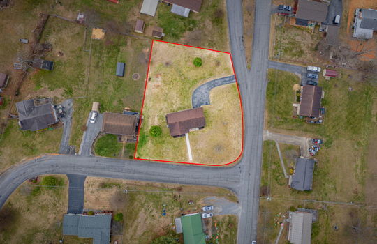 overhead aerial view of home, road, front yard, roof, driveway, back yard, neighboring homes, property outline