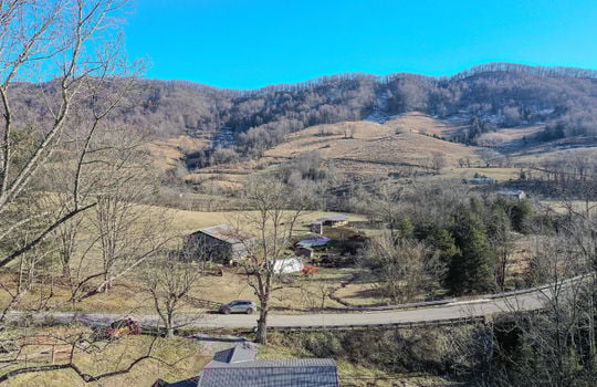 aerial view of home from back yard, roof, road, neighboring properties, mountain view