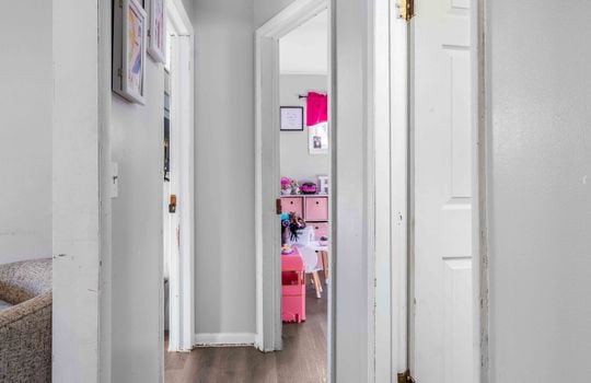 hallway, luxury vinyl flooring, doors to bedrooms
