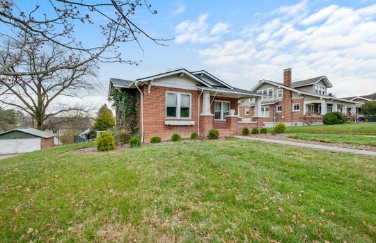 bungalow, brick, covered front porch, sidewalk, landscaping, front yard, windows