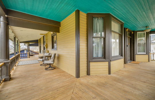 covered front porch, wood ceiling, wood porch, wrap-around porch, front door, windows