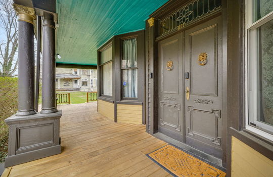 front door, double entry front door, door knockers, wood siding, covered porch, wood ceiling, windows