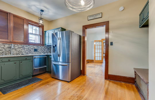 kitchen, cabinets, countertops, granite countertops, stainless appliances, refrigerator, dishwasher, sink, tile backsplash, hardwood flooring, windows, window above sink