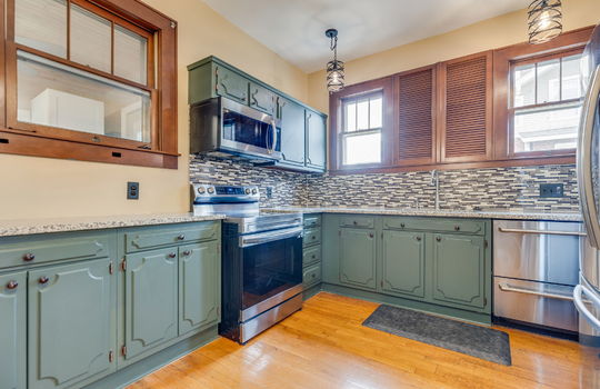 kitchen, cabinets, granite countertops, refrigerator, dishwasher, sink, range, built-in microwave, window above sink, tile backsplash, hardwood flooring