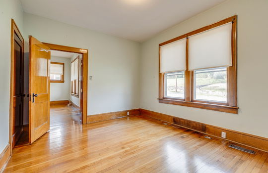 bonus room/home office, closet, wood trim, hardwood flooring, windows