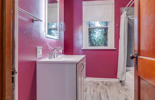 bathroom, sink, tub/shower, toilet, window