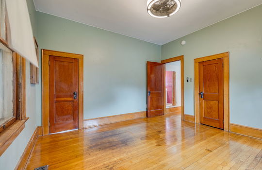 bedroom, closets, hardwood flooring, windows, ceiling fan, wood trim