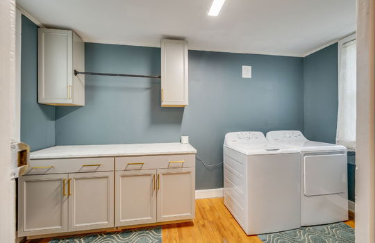 laundry room, hardwood flooring, cabinets, countertops, window