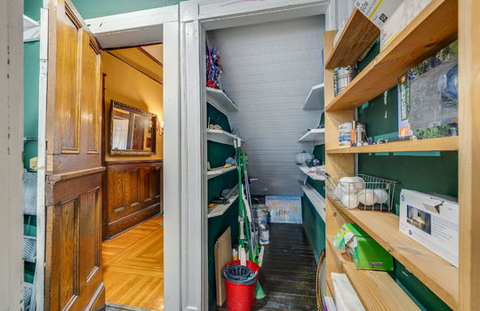 pantry/storage, hardwood flooring, storage shelves, door