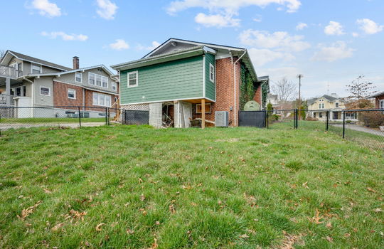 back of home, brick and siding exterior, fencing, back yard