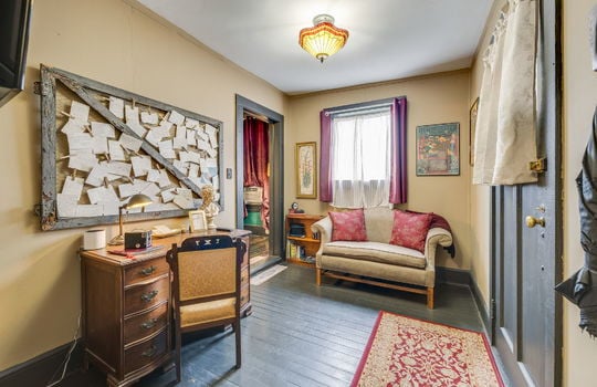 living room/sitting area, hardwood flooring, private entry door, window