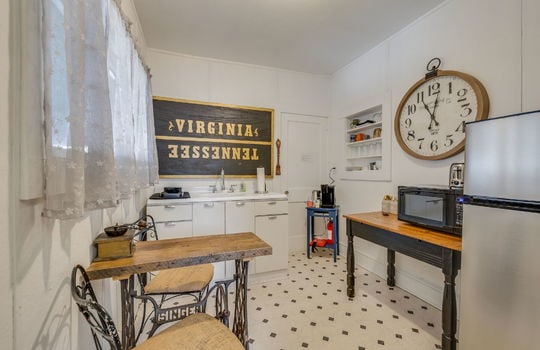 kitchenette, sink, tile flooring, cabinets, refrigerator, window