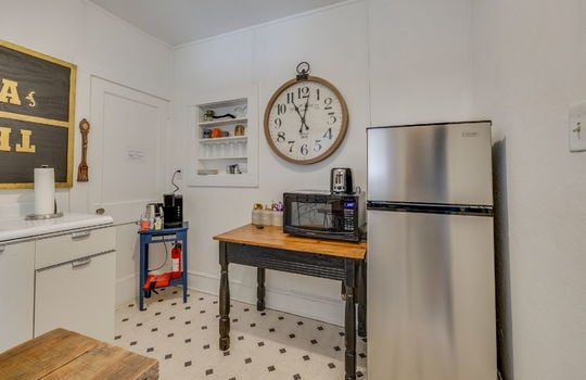 kitchenette, refrigerator, built in shelving, cabinets