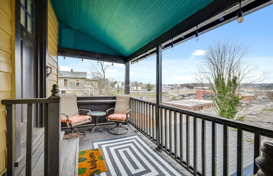 balcony, private entry to rental suite, views of downtown Bristol, wood door, covered balcony
