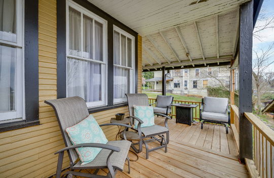 wrap around porch, covered porch, new wood banisters, wood siding, windows