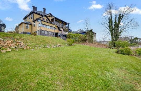back view of home, storage shed, yard, wood siding, victorian home, nearby homes