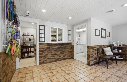 reception area, reception window, exam room door, stone wall design, tile flooring, recessed lighting