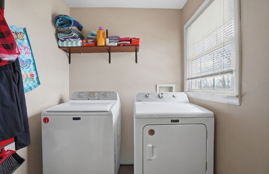 Laundry room, washer/dryer hookups, window, storage shelf