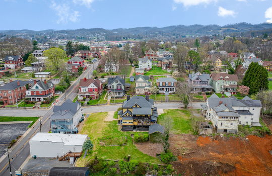 back of home, nearby homes, victorian home two story home, back yard, mountains