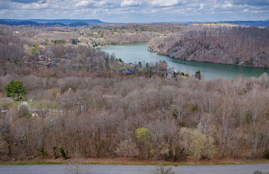 aerial photo, land for sale, 1.09+/- acres, road, trees, neighboring properties, lake, mountains