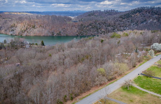 aerial photo, land for sale, 1.09+/- acres, road, trees, neighboring properties, lake, mountains