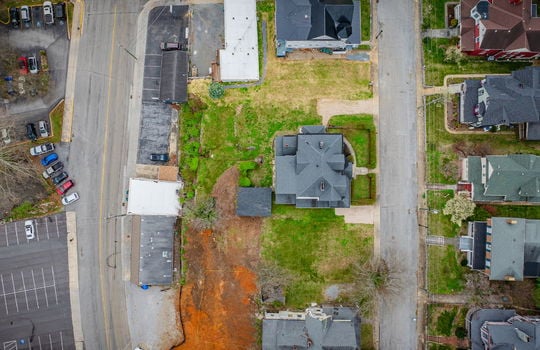 overhead Aerial view of home, victorian home, street, front yard, hedge, gravel driveways, sidewalk, nearby homes, shed, road
