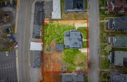 overhead Aerial view of home, victorian home, street, front yard, hedge, gravel driveways, sidewalk, nearby homes, shed, road, property outline