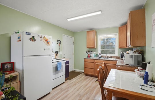 Kitchen, refrigerator, range, sink, cabinets, countertops, exterior door, windows, laminate flooring