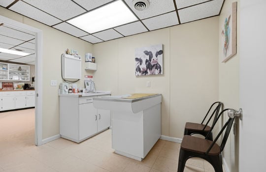 exam room, exam table, tile flooring, ceiling tiles, fluorescent lighting, sink