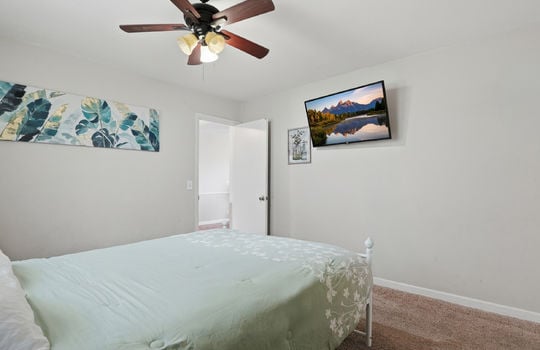 bedroom, carpet, ceiling fan, doorway to hallway