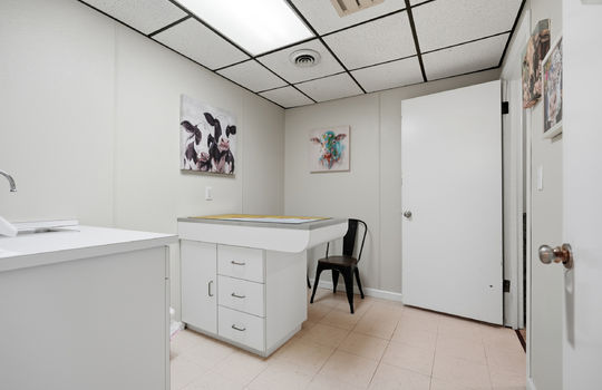 exam room, exam table, tile flooring, ceiling tiles, fluorescent lighting, sink