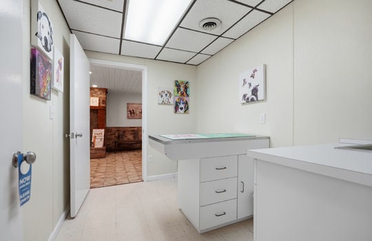 exam room, exam table, tile flooring, ceiling tiles, fluorescent lighting, sink