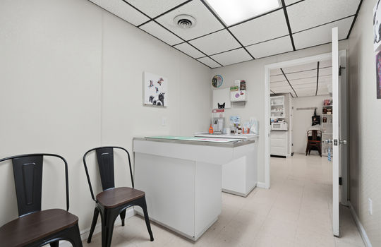 exam room, exam table, tile flooring, ceiling tiles, fluorescent lighting, sink
