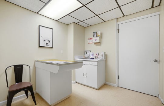 exam room, exam table, tile flooring, ceiling tiles, fluorescent lighting, sink