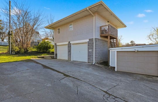 Apartment, Drive under 2 Car garage, vinyl siding, driveway, stairs to upper level