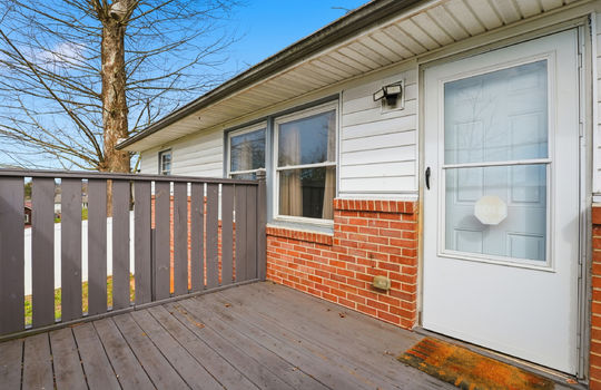 back deck, brick, vinyl siding, storm door, entry door,
