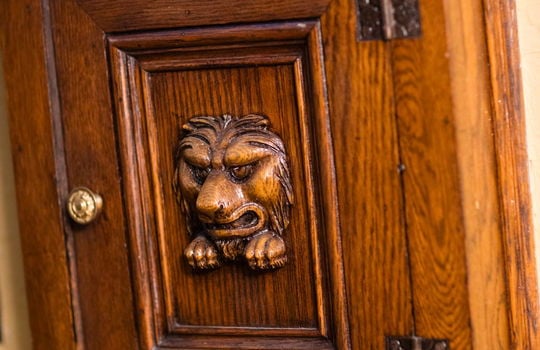 tiny wood door with lion detail