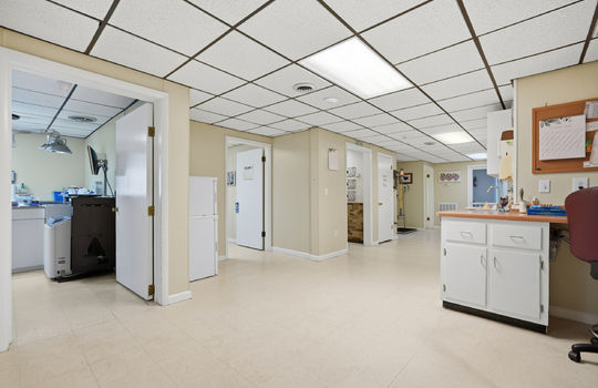 inner office area, work stations, exam rooms, tile flooring, doorway to exam rooms