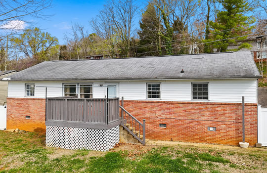back of home, brick, vinyl siding, back deck, stairs to back deck, back yard, fencing