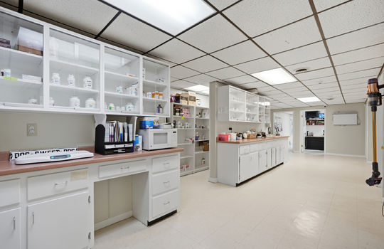 inner office area, storage cabinets, workstations, storage, tile flooring, ceiling tiles, fluorescent lighting