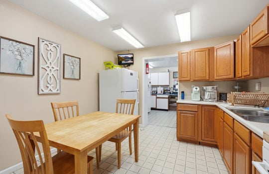 eat in kitchen area/break room, cabinets, sink, refrigerator